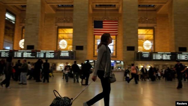 A woman pulls her luggage at Grand Central Station while Hurricane Sandy approaches New York, October 28, 2012.
