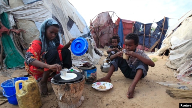 An internally displaced Somali girl prepares the traditional Somali breakfast "Anjero" at Sayyidka camp in the Howlwadag district, south of Somalia's capital Mogadishu, May 3, 2013. 