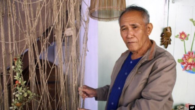 Boonrian Chinnarat holds a net he once used to catch giant catfish at his house in Chiang Kong district of Chiang Rai province, northern Thailand, Feb. 7, 2011. He blames the disappearance of the fish partly on China's upstream dams.