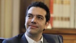 Greek leader of Coalition of the Radical Left party (SYRIZA) Alexis Tsipras looks on during a meeting with Greek President Karolos Papoulias, to formally take the mandate to form a coalition government in Athens. 