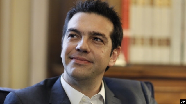 Greek leader of Coalition of the Radical Left party (SYRIZA) Alexis Tsipras looks on during a meeting with Greek President Karolos Papoulias, to formally take the mandate to form a coalition government in Athens. 