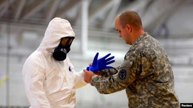The U.S. sent about 3,000 soldiers to fight Ebola. Here James Knight of U.S. Army Medical Research Institute of Infectious Diseases (USAMRIID) trains U.S. Army soldiers from the 101st Airborne Division (Air Assault) before their deployment to West Africa.