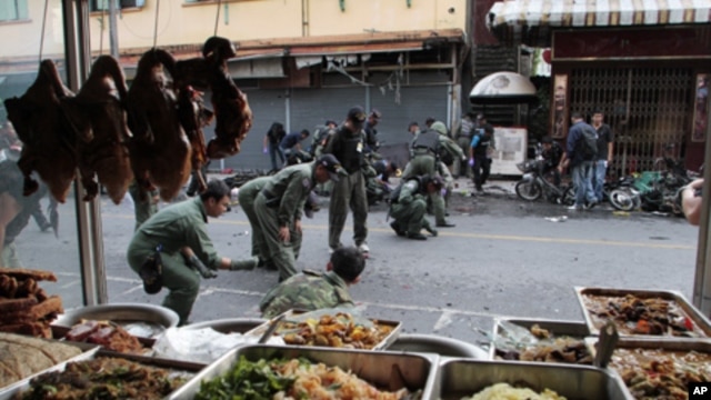 Thai security personnel collect evidence as they investigate at the site of a bomb attack in the southern Yala province, Feb. 21, 2011.