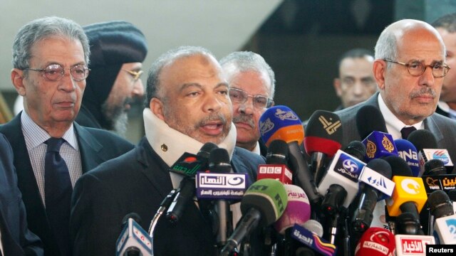 Saad al-Katatni, head of the Egyptian Muslim Brotherhood's Freedom and Justice party, talks during a news conference next to former Foreign Minister Amr Moussa (L) and liberal politician Mohamed ElBaradei (R) after their meeting in Cairo, January 31, 2013.