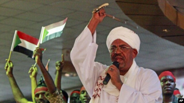 Supporters wave Sudanese flags as Sudanese President Omar al-Bashir addresses supporters during a rally at the ruling National Congress Party  headquarters in Khartoum, Sudan, April 18, 2012.