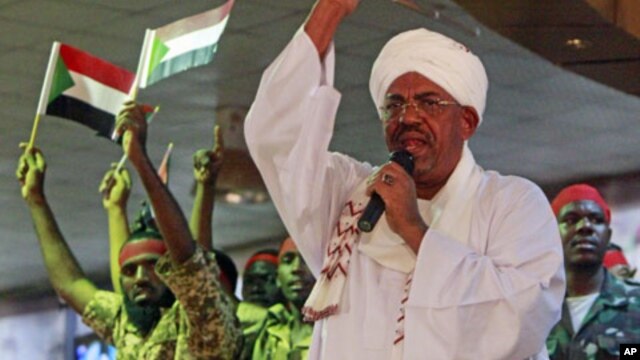 Supporters wave flags as Sudanese President Omar al-Bashir addresses a rally in Khartoum, Sudan, April 18, 2012.
