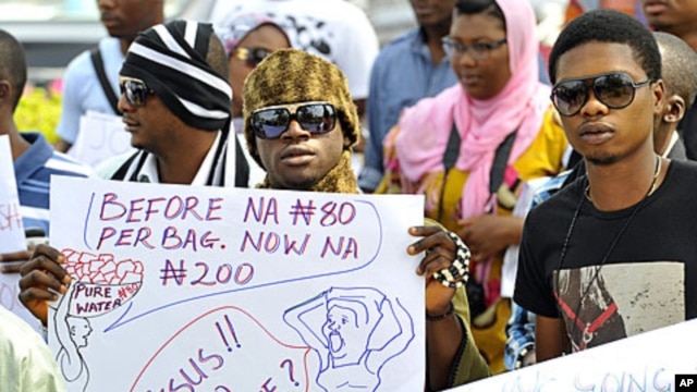 A protester carries a placard during a rally against fuel subsidy cuts in Nigeria's capital, Abuja, January 6, 2012.