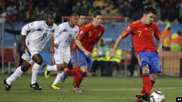 Spain's David Villa, right, takes a penalty kick during the World Cup group H soccer match between Spain and Honduras at Ellis Park Stadium in Johannesburg, South Africa, Monday, June 21, 2010.