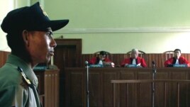 A Cambodian police officer guards the Appeals Court in Phnom Penh, Cambodia, as the judges read their verdict in front of an empty dock, file photo. 