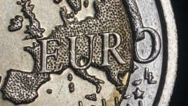 The map of Europe is featured on the face of a two Euro coin seen in this photo illustration. 