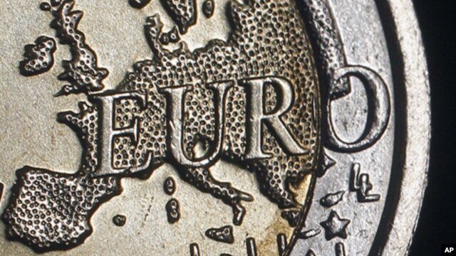 The map of Europe is featured on the face of a two Euro coin seen in this photo illustration. 