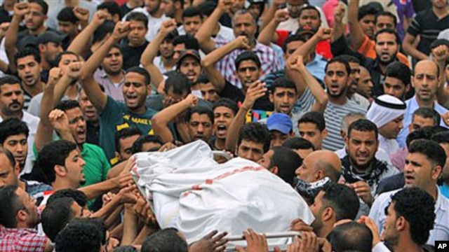Mourners chant anti-government slogans as they carry the body of Ali Isa Saqer, 31, to be washed for burial in his village of Sehla, Bahrain, April 10, 2011, after he died in police custody in the past week