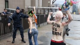 Femen members protest Putin's human rights record, European Union Council building, Brussels, Dec. 21, 2012.