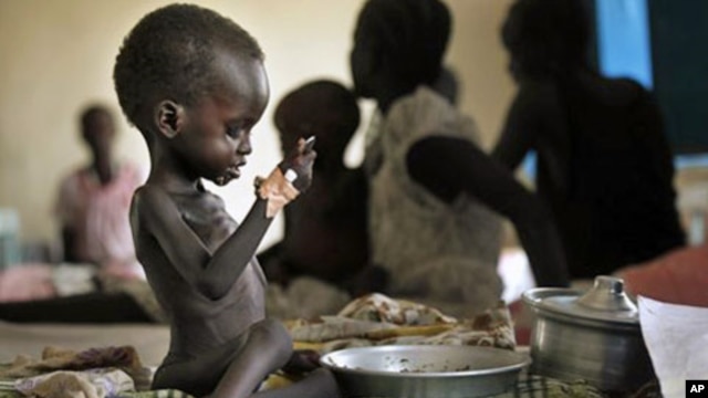 Two-year-old Nyagod Kuel attempts to eat on her bed in a hospital ward in Akobo, southeastern Sudan. The U.N. mission dubs the "hungriest place on earth". (File)
