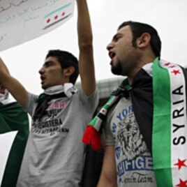 Syrian Kurds wearing Syrian opposition flags chant participate in a sit-in in front of UN headquarters in Beirut, Lebanon, in solidarity with anti-government protesters in Syria, April 29, 2012.