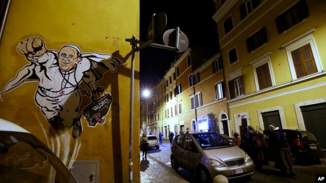 A graffiti depicting Pope Francis as Superman and holding a bag with a writing which reads: 'Values' is seen on a wall of the Borgo Pio district near St. Peter's Square in Rome, Tuesday, Jan. 28, 2014. 