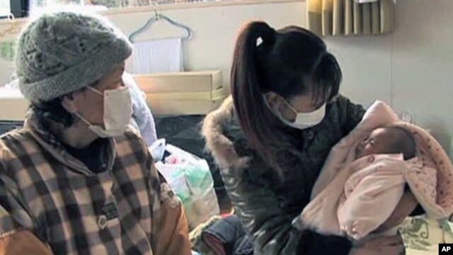 These people care for their infant, and are among more than 430,000 forced into emergency shelters after the earthquake and tsunami struck Japan on March 11 of this year, in Sendai, Japan, August 2011