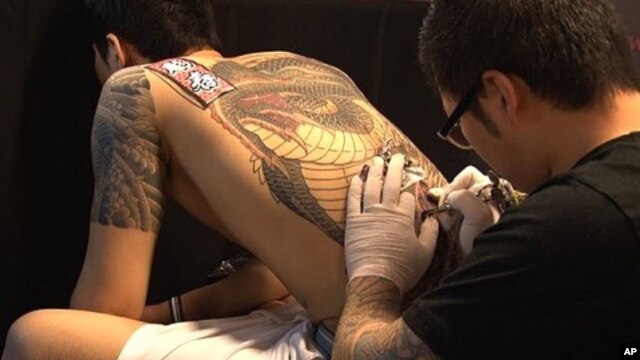 A tattoo artist at work during  Ink Bomb 2011 in Seoul, South Korea