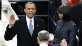 U.S. President Barack Obama is sworn in by Supreme Court Chief of Justice John Roberts, as first lady Michelle Obama looks on during inauguration ceremonies in Washington, D.C., January 21, 2013.