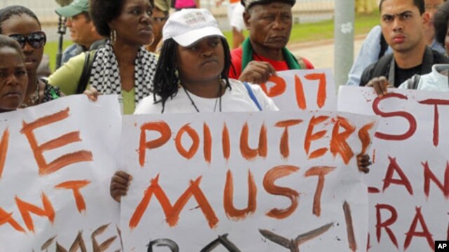Environmental activists demonstrate outside the United Nations Framework Convention on Climate Change Conference of the Parties meeting in Durban, November 29, 2011.