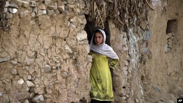 An Afghan refugee girl outside her home in slums of Islamabad, Pakistan, May 16, 2012.