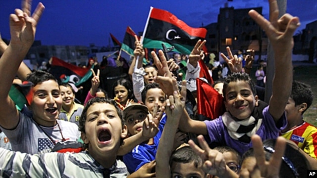 Libyan children  celebrate in Souk el-Juma district in Tripoli, Libya,  Oct. 21, 2011.
