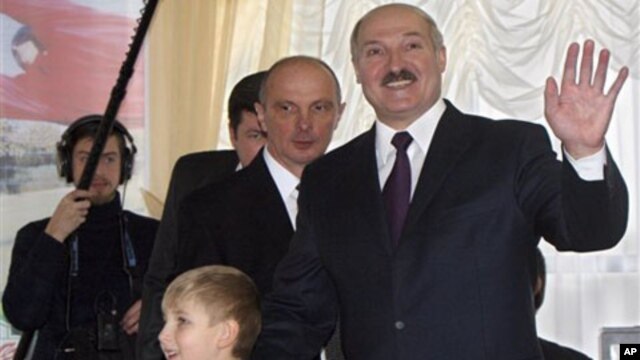 Incumbent Belarusian President Alexander Lukashenko with his son, Nikolai, at a polling station in the capital, Minsk, 19 Dec 2010