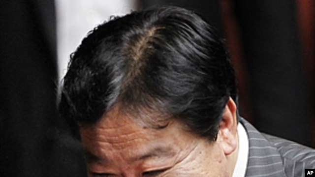 Yoshihiko Noda, new leader of the ruling Democratic Party of Japan, reacts before Japan's lower house elected Noda as the country's new prime minister, at the parliament in Tokyo, August 30, 2011