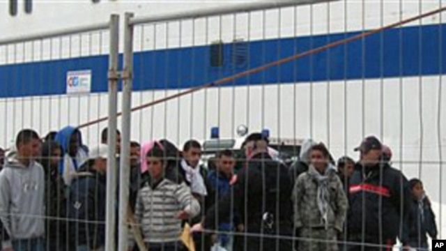 Would-be migrants believed to be from Tunisia at the port of the Sicilian island of Lampedusa, February 11, 2011