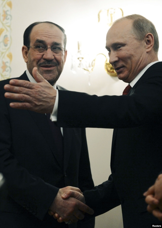 Russian President Vladimir Putin (R) welcomes Iraqi Prime Minister Nuri al-Maliki in his Novo-Ogaryovo residence outside Moscow, October 10, 2012.