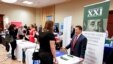 FILE - Corporate representatives speak with job seekers at a job fair in Pittsburgh, Pennsylvania, March 30, 2016. 
