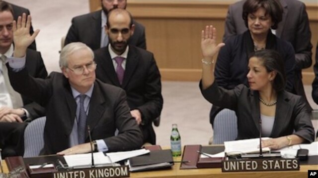 British Ambassador to the United Nations Mark Lyall Grant and American Ambassador Susan Rice vote during a Security Council vote on the peace and security in Africa,  Saturday, Feb. 26, 2011 at U. N. headquarters.