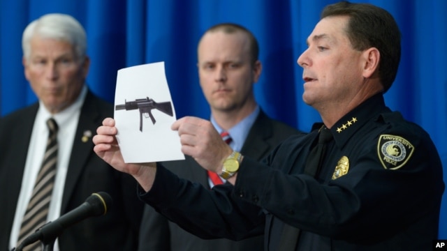 University of Central Florida police Chief Richard Beary, right, shows an example of the assault rifle, along with explosive devices, found in the dorm room of James Oliver Seevakumaran, Monday, Mar. 18, 2013, in Orlando, Fla.