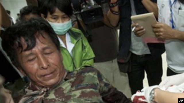 An injured Thai soldier is treated on his arrival at Kantharalak, hospital in Si Sa ket Province, Thailand Sunday, Feb. 6, 2011