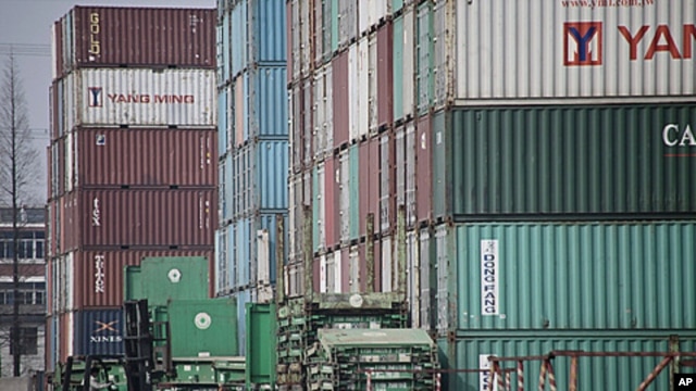 Forklift arranges shipping containers near Shanghai port, China, March 2, 2011 (file photo).