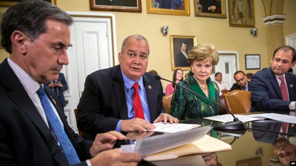 FILE - Rep. Gary Palmer, R-Ala., left, and fellow representatives and delegates work on legislation to create a financial control board for Puerto Rico and restructure some of the U.S. territory's $70 billion debt, June 8, 2016. 