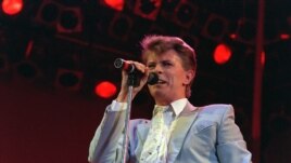 Rock star David Bowie performs on stage at Wembley Stadium, London, July 13, 1985, during the Live Aid famine relief rock concert. (AP Photo/Joe Schaber)