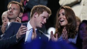 Britain's Prince Harry (L) and Dutchess of Cambridge Kate Middleton (R) applaud as they view the closing ceremony of the London 2012 Olympic Games at the Olympic Stadium August 12, 2012.  