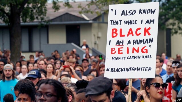 Hundreds gather at the JJ Hill Montesorri School Thursday, July 7, 2016, in St. Paul, Minn. for a vigil following the shooting death by police of Philando Castile.
