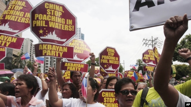 Protesters march towards the Chinese consulate during a rally in Manila's financial district of Makati, Philippines, May 11, 2012.