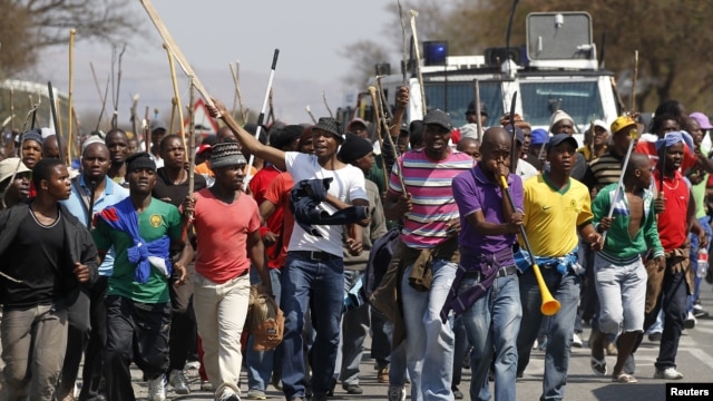 Mineworkers take part in a march outside the Anglo American mine in South Africa's North West Province, September 12, 2012. 