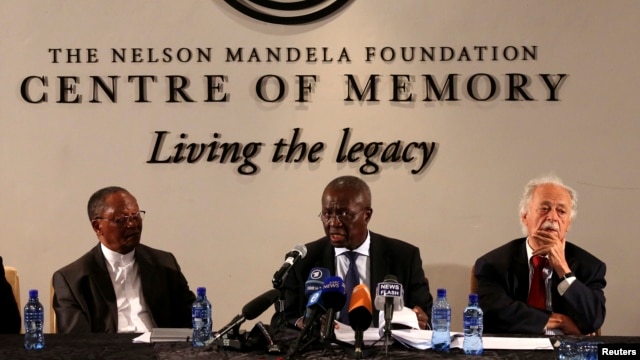 Deputy Chief Justice Dikgang Moseneke (C) reads Mandela's will as he is flanked by Professor Njabulo Ndebele (L) and Advocate George Bizos, Nelson Mandela's lawyer, confidant and friend at the Nelson Mandela Center of Memory in Houghton, Feb. 3, 2014.