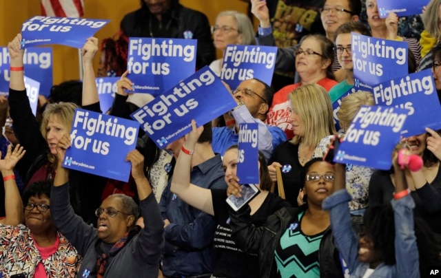 Supporters react to positive primary results for Democratic presidential candidate Hillary Clinton before a rally at Cuyahoga Community College in Cleveland, March 8, 2016.