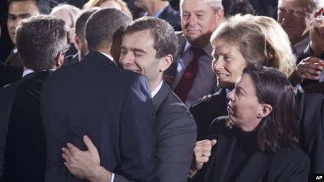 A member of the audience hugs President Barack Obama at the Interior Department in Washington after he signed the "Don't Ask, Don't Tell" repeal legislation that would allow gays to serve openly in the military, 22 Dec 2010