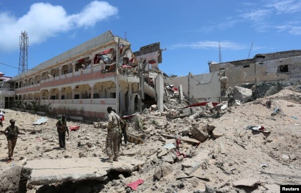 Security forces stand at the SYL hotel that was partly destroyed following a car bomb claimed by al Shabab Islamist militants outside the president's palace in the Somali capital of Mogadishu, August 30, 2016.