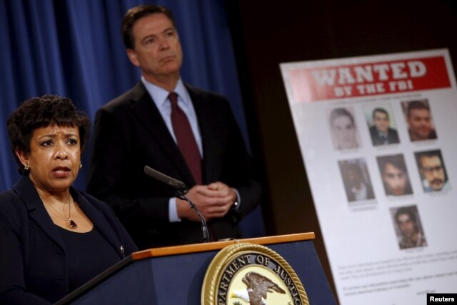 FILE - U.S. Attorney General Loretta Lynch and FBI Director James Comey hold a news conference to announce indictments on Iranian hackers for a coordinated campaign of cyber attacks on several U.S. banks and a New York dam, at the Justice Department in Washington, March 24, 2016.