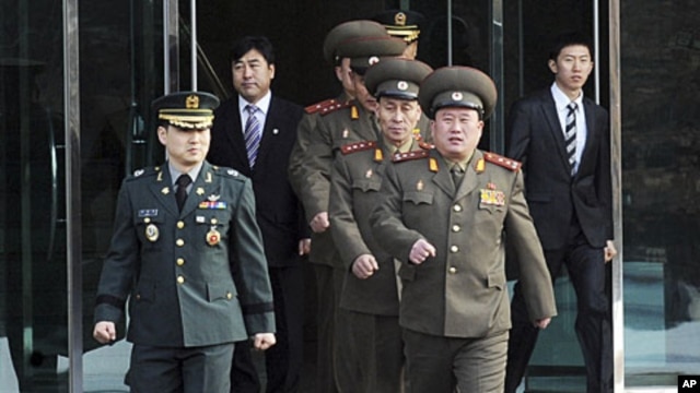 North Korean Colonel Ri Son-kwon (front R) and other North Korean officers walk south of the truce village of Panmunjom in Paju, north of Seoul, February 8, 2011