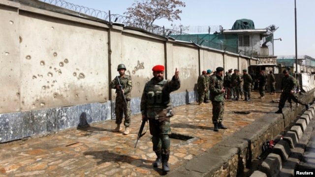 Afghan National Army soldiers keep watch at the site of attack in Kabul, March 9, 2013. 