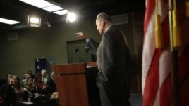 Sen. Charles Schumer, D-N.Y., accompanied by Sen. Kirsten Gillibrand, D-N.Y, calls on a reporter during a news conference on Capitol Hill in Washington, Friday, Jan. 4, 2013, to discuss Superstorm Sandy aid.