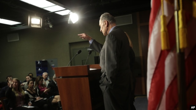 Sen. Charles Schumer, D-N.Y., accompanied by Sen. Kirsten Gillibrand, D-N.Y, calls on a reporter during a news conference on Capitol Hill in Washington, Friday, Jan. 4, 2013, to discuss Superstorm Sandy aid.